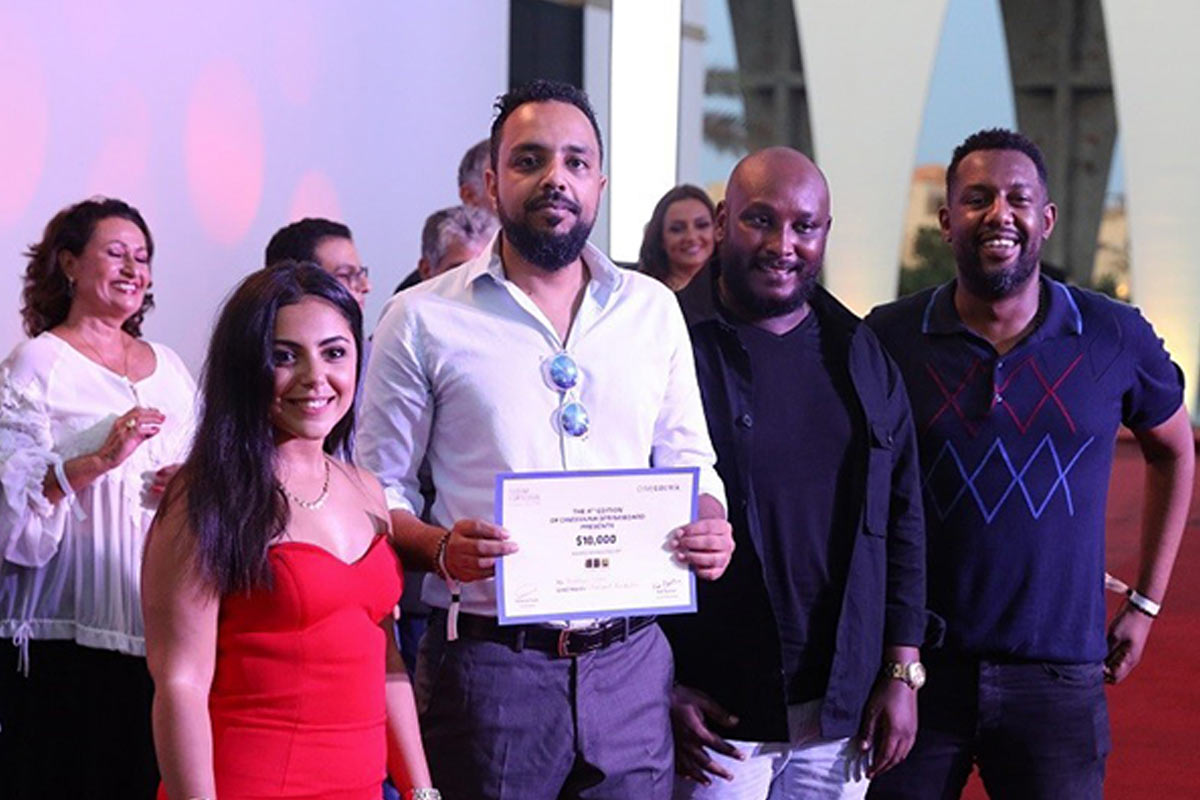 Group of mixed ethnicity winners with certificates and awards