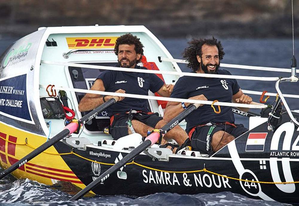 two men rowing a boat